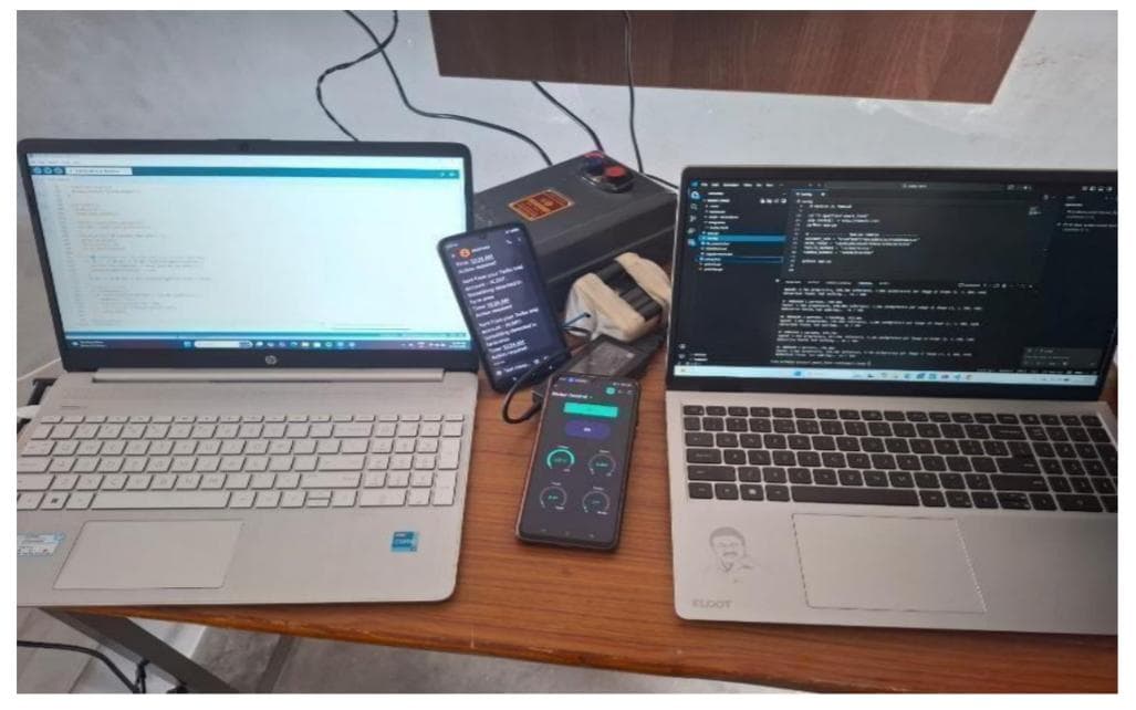 Automatic and Remote Motor Control System by SkillForge Technology Erode — mobile control dashboard, development setup on two laptops with VS Code and motor controller hardware enclosure